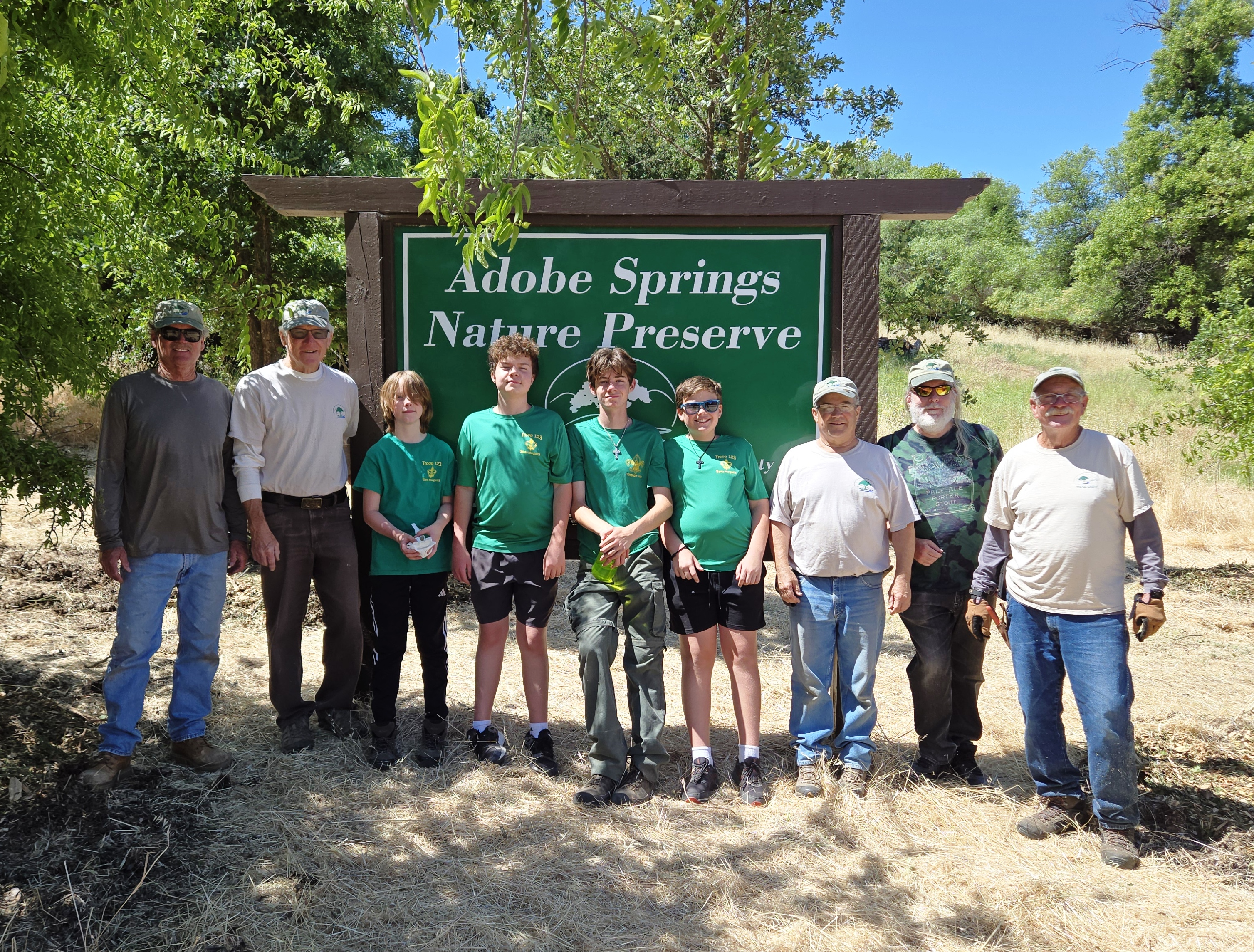 Some of the volunteers in front of the sign